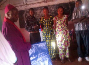 Bishop Kasima Corneille presents poles and tarpaulins for the construction of new churches